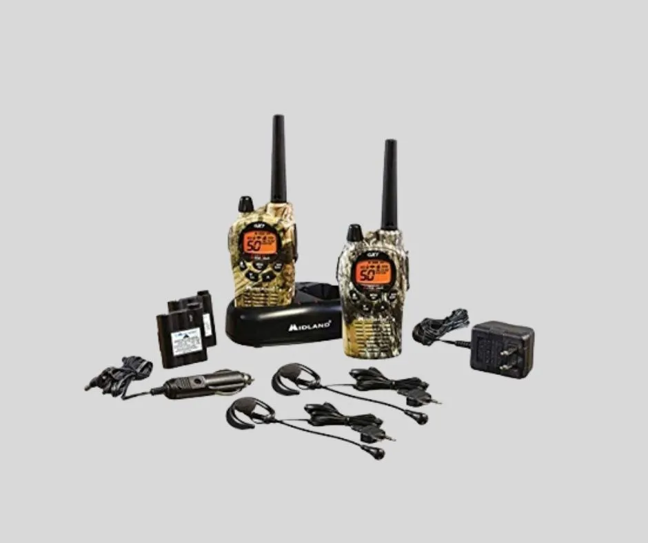 "Uniden long-range two-way radio set for hunters, featuring two camouflage radios with headsets, dual charging cradle, car charger, wall adapter, and extra batteries on a gray background."