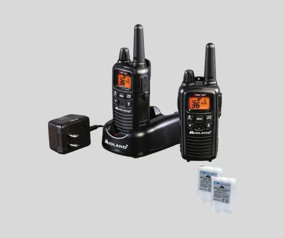 "Two black Midland LXT600VP3 FRS walkie talkies on a charging dock with a power adapter and two rechargeable battery packs."