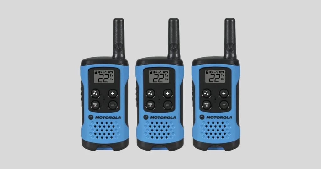 Three blue Motorola T100TP Talkabout radios with antennas and digital displays, arranged on a gray background.